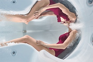 an underwater view demonstrating how a person fits perfectly in a well fitted hot tub seat