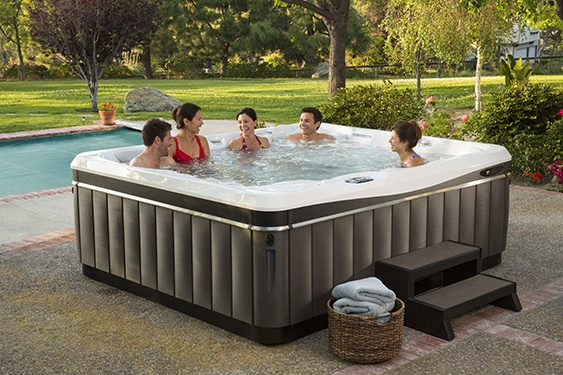 friends improve their relationship with a soak in a utopia cantabria hot tub on a beautiful sunny backyard patio