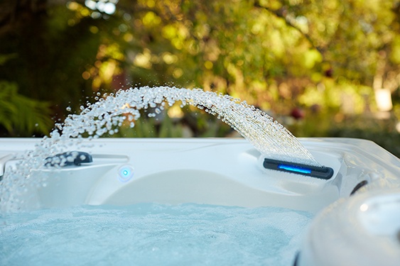 a close-up image of the waterfall feature on a Caldera spa that adds value to the hot tub experience a close-up image of the waterfall feature on a Caldera spa that adds value to the hot tub experience